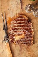 beef steak with vintage meat fork photo