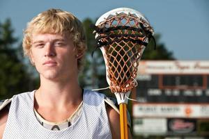 Lacrosse player with lacrosse stick photo