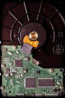 Hard disk base with green microcircuit components photo