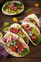 Mexican tacos with meat, beans and salsa photo