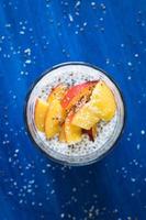 Coconut milk chia seeds pudding served with nectarine slices photo