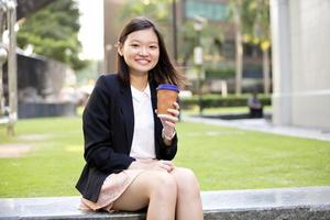 Young female Asian executive holding file