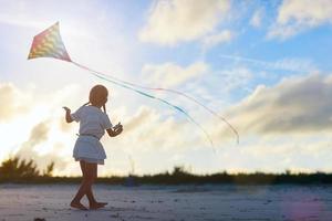 Little girl flying a kite photo