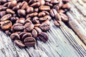 Coffee beans  on grunge wooden background. photo