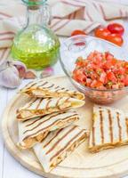 Homemade chicken and cheese quesadilla with salsa photo