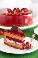 Chocolate cherry cake covered with a mirror coating. photo