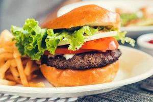 Fresh burger with cheeseand french fries outdoors photo