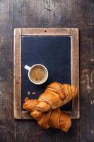 Coffee cup and croissants photo