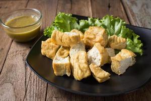 Fried bean curd eaten with sauce photo