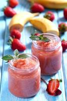 Strawberry banana smoothie in glass jars photo