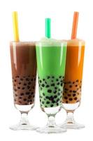 Brown, green and orange bubble teas with colorful straws photo