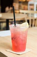 Cold Strawbery Italian soda in a glass with ice cubes photo