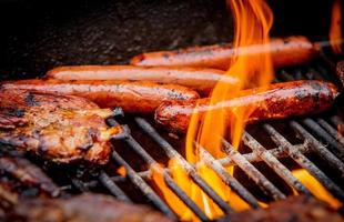 hot dogs and ribs on a grill photo