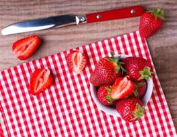 Fresh strawberries on the wooden table photo
