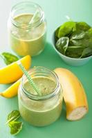 healthy green smoothie with spinach mango banana in glass jars photo