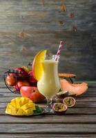 Tropical mango, melon, peach and passion fruit smoothie for heal