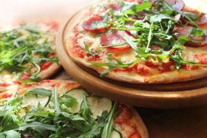 Pizza with sausage, cheese, ruccola photo