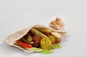 falafel with vegetables in pita bread and sauce