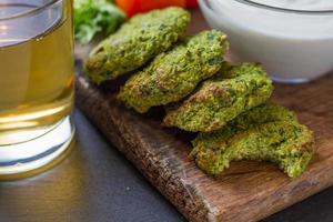 Falafel served with salad, cherry tomatoes and beer photo