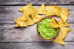 homemade guacamole with corn chips top view