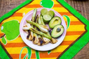 Grilled onions, sliced avocad and limes photo
