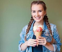 Beautiful girl holds a huge ice cream in waffle cone