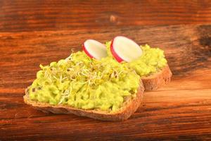 Sandwiches with avocado, radish and germs photo