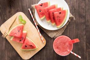 Top view healthy watermelon smoothie on a wood background photo