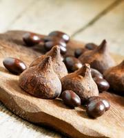 Chocolates truffles and balls on a wooden background