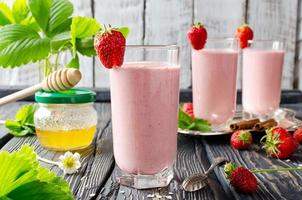 Strawberry smoothie on a wooden table photo