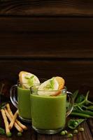 Green pea soup with croutons and cheese. photo