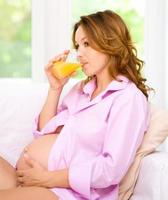 Pregnant woman drink orange juice photo