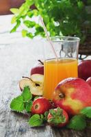 fruit juice, ripe apples and strawberries photo
