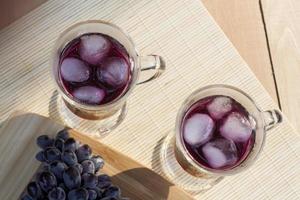Grape juice and fresh blue grapes
