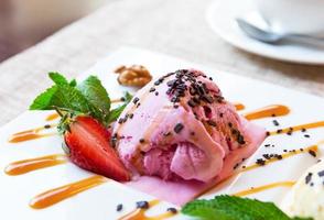 Three scoops of pistachio, strawberry and vanilla ice cream