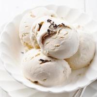 Ice cream with Earl grey tea flavor. White ceramic bowl photo