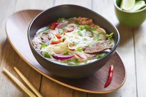 Rice noodle soup with sliced beef photo
