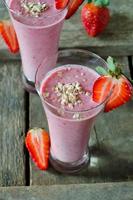 Strawberry smoothie on a wooden table photo