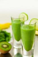 Green Smoothie with Fruits in Background photo