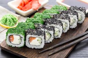 Sushi roll covered with dill and sesame