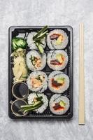 sushi menu in black transportbox or bento box gray background, photo