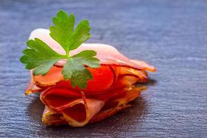 Curled Slices of Delicious Prosciutto with parsley leaves