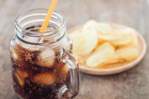 Iced cola with potato chips photo
