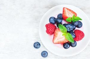 souffle cake with fresh raspberries, blueberries and strawberries photo