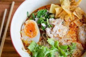 Tomyum noodle with pork and egg photo