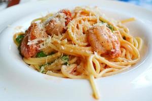 Delicious pasta spaghetti with shrimps and other seafood photo