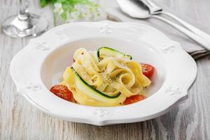 pasta with zucchini tomatoes and parmesan cheese photo