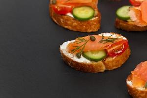 Finger food canape with smoked salmon photo