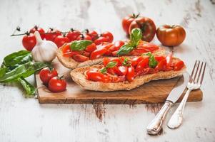 Italian starter, bruschetta with Sicilian red fresh tomato on a photo