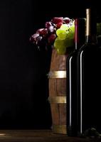 Red and white wine on wooden background